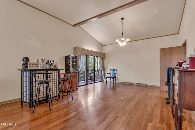 interior space with high vaulted ceiling, an inviting chandelier, light hardwood / wood-style flooring, bar, and beam ceiling