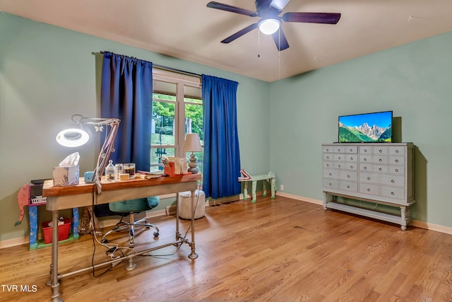 home office featuring light hardwood / wood-style flooring and ceiling fan