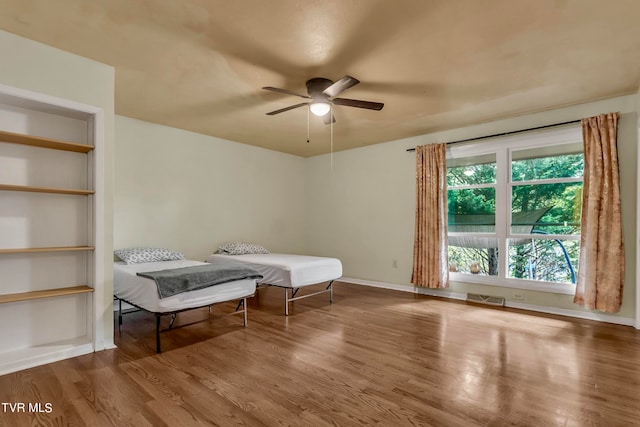 bedroom with hardwood / wood-style flooring and ceiling fan