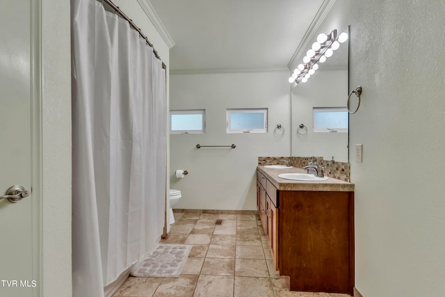 bathroom featuring crown molding, vanity, and toilet