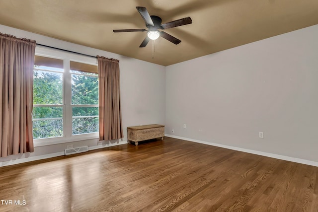 spare room featuring ceiling fan, plenty of natural light, and hardwood / wood-style floors