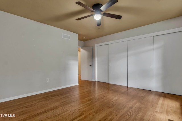 unfurnished bedroom featuring a closet, ceiling fan, and hardwood / wood-style floors