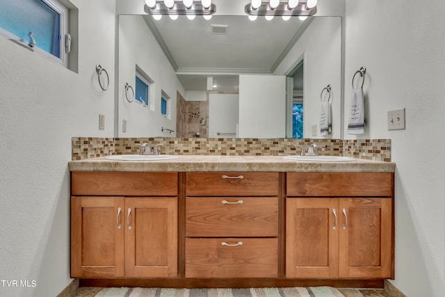 bathroom with a shower, vanity, backsplash, and crown molding