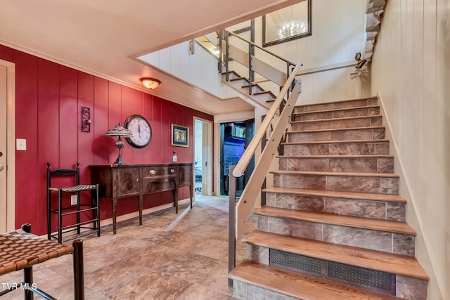 stairway featuring wood walls