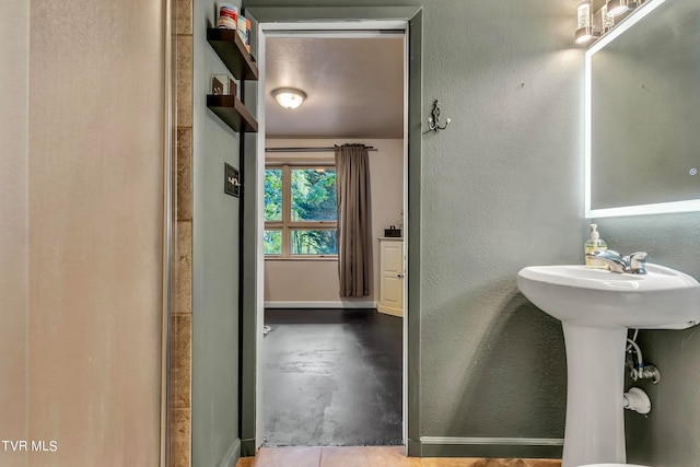 bathroom with concrete flooring and walk in shower