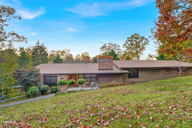 ranch-style house with a patio and a front yard