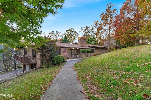 view of front of property featuring a front lawn and a deck