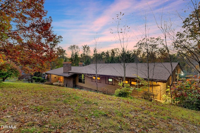 back house at dusk with a yard