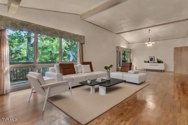 living room featuring vaulted ceiling with beams, light hardwood / wood-style flooring, and a notable chandelier