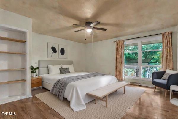 bedroom with hardwood / wood-style floors and ceiling fan