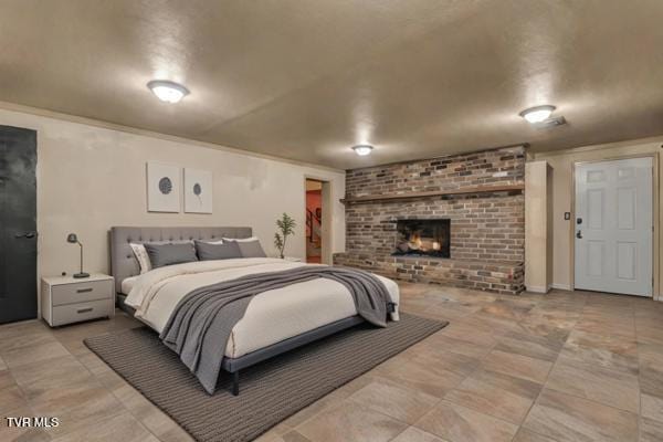 bedroom with a brick fireplace