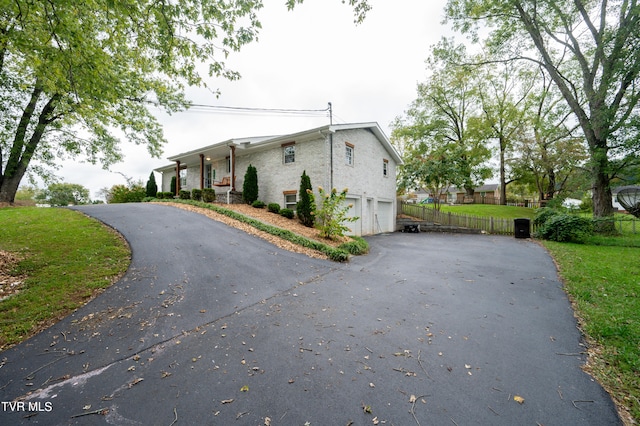 view of property exterior with a lawn and a garage