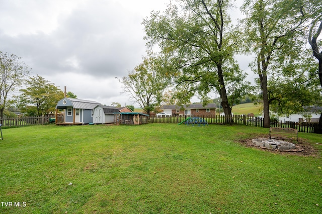 view of yard featuring a playground and a shed