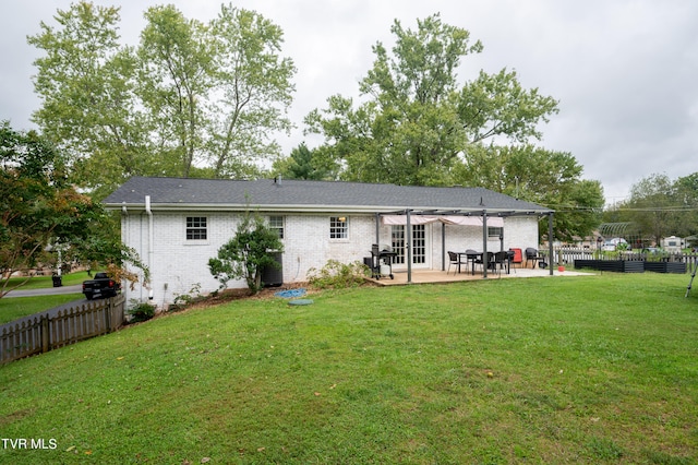 back of house with a lawn and a patio