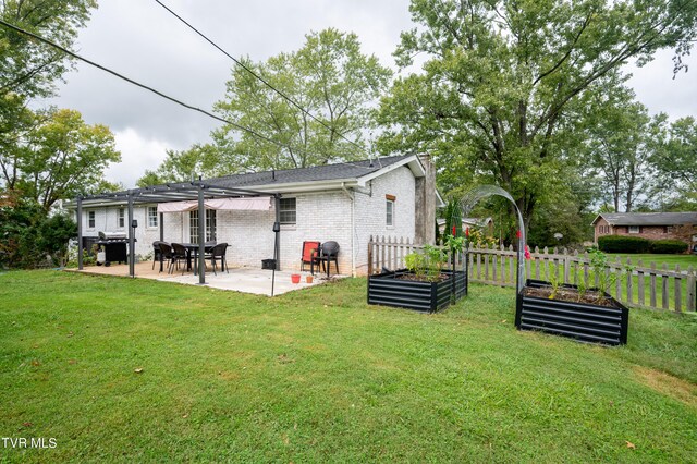 back of house featuring a pergola, a lawn, and a patio area