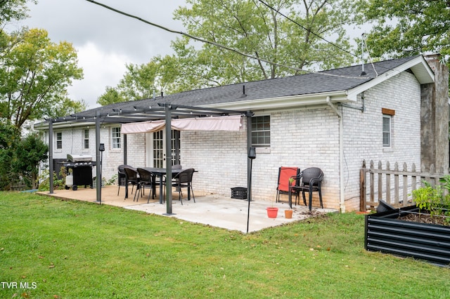 rear view of house with a yard and a patio area