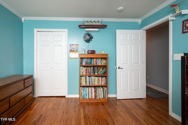 unfurnished bedroom featuring crown molding, dark wood-type flooring, and a closet