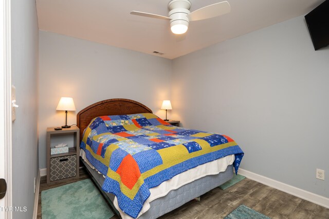 bedroom with dark wood-type flooring and ceiling fan