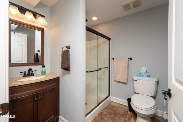 bathroom with tile patterned flooring, vanity, toilet, and an enclosed shower