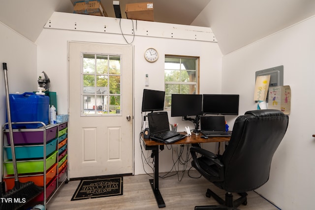 office space featuring light wood-type flooring and lofted ceiling