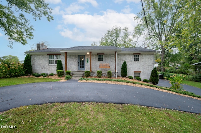 view of front of property with a front yard and covered porch