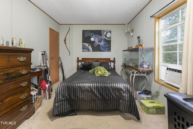 bedroom with carpet, cooling unit, and a textured ceiling