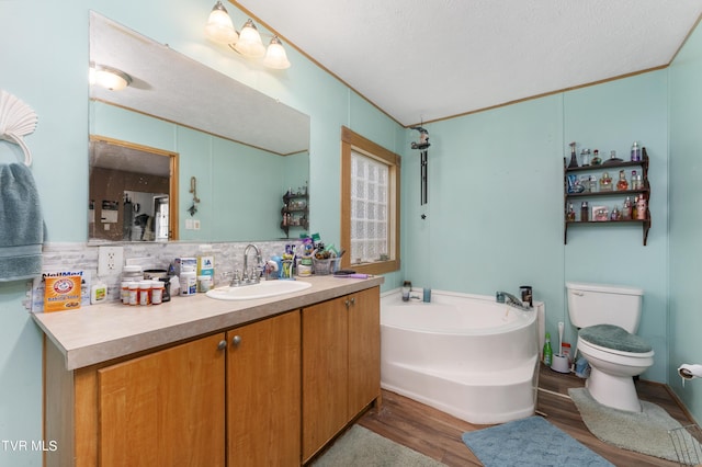 bathroom with a bath, backsplash, a textured ceiling, vanity, and hardwood / wood-style flooring