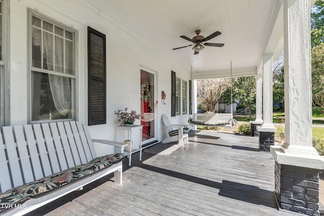 wooden deck featuring a porch and ceiling fan