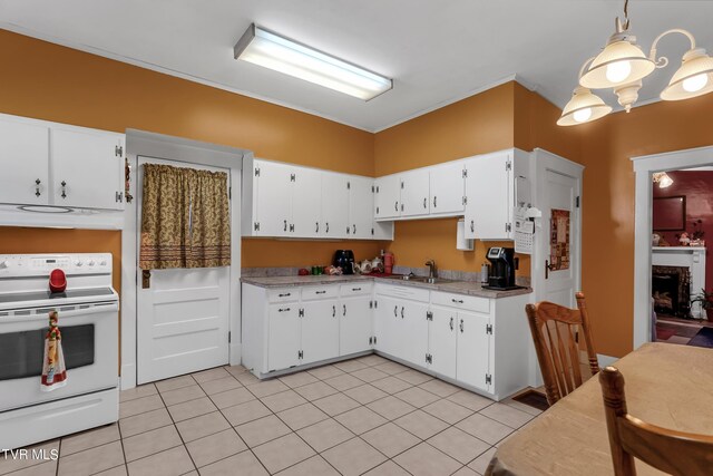 kitchen with white range oven, light tile patterned flooring, white cabinets, decorative light fixtures, and sink