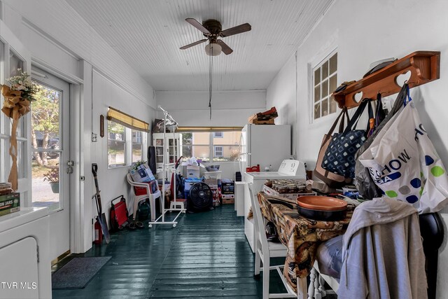 sunroom / solarium with washer / dryer, ceiling fan, and a healthy amount of sunlight