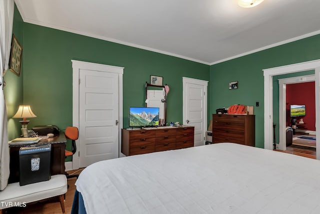 bedroom featuring crown molding and hardwood / wood-style floors