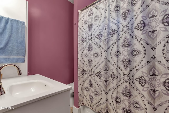 bathroom featuring walk in shower, vanity, and toilet