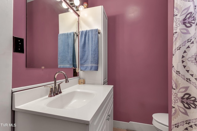 bathroom featuring vanity and toilet