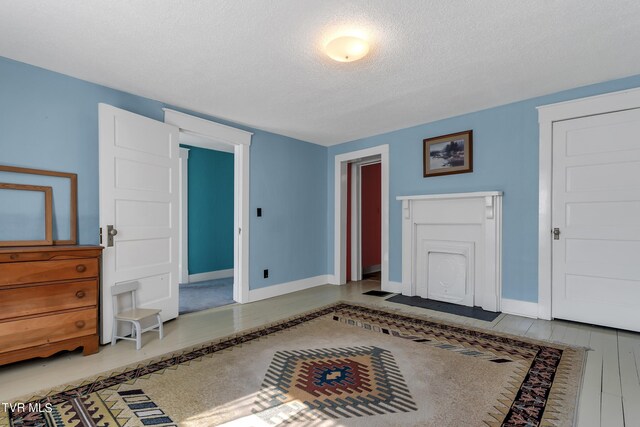 interior space with a textured ceiling and hardwood / wood-style flooring