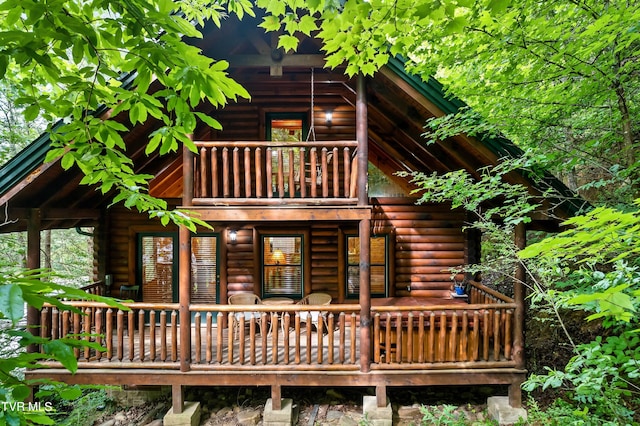 rear view of property featuring a balcony