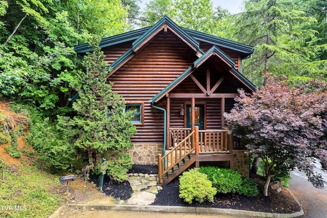 log-style house with covered porch