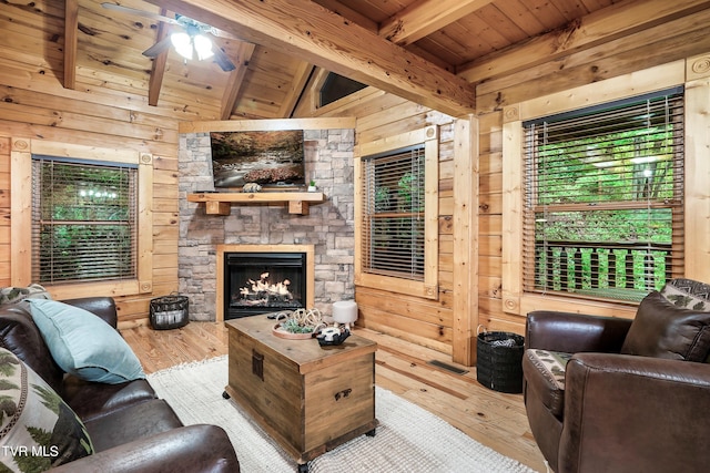 living room with vaulted ceiling with beams, wood walls, hardwood / wood-style floors, and plenty of natural light