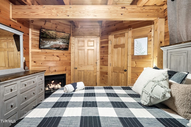 bedroom featuring wood ceiling, wooden walls, and beamed ceiling