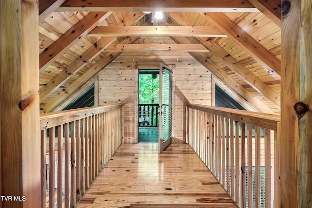 bonus room featuring light hardwood / wood-style flooring, lofted ceiling with beams, wood walls, and wooden ceiling