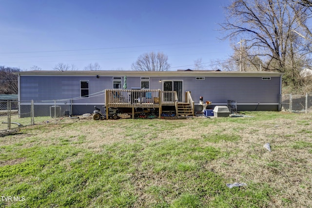 back of property featuring a deck, a yard, and fence