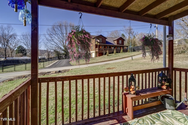 wooden terrace featuring a yard