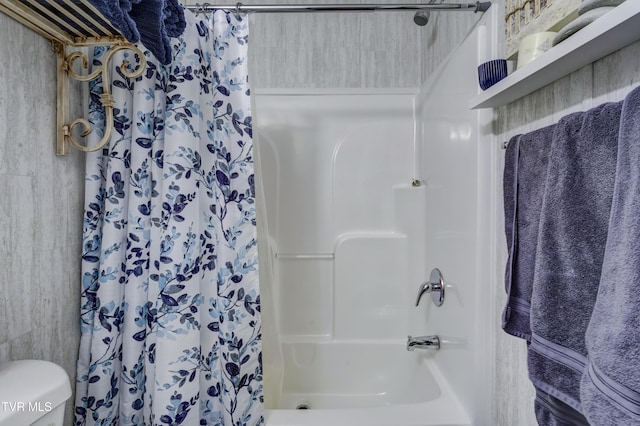 bathroom featuring curtained shower and toilet