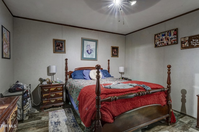 bedroom featuring ceiling fan, crown molding, and wood finished floors