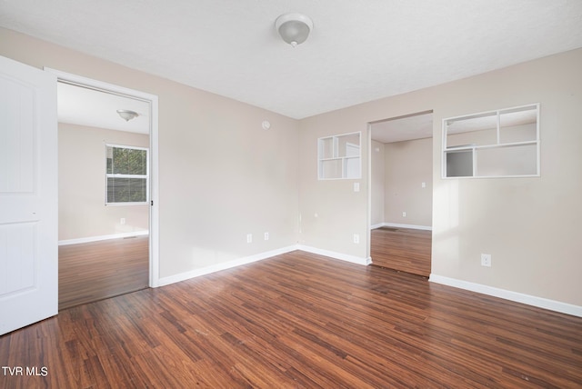 spare room featuring dark hardwood / wood-style floors