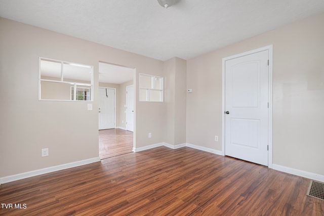 spare room featuring dark hardwood / wood-style flooring