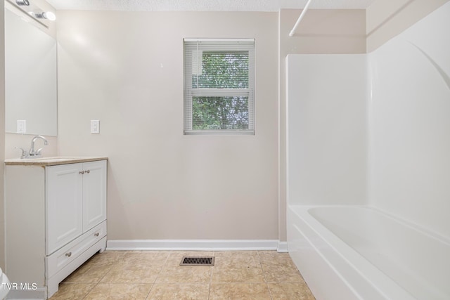 bathroom with vanity, tile patterned flooring, and a textured ceiling