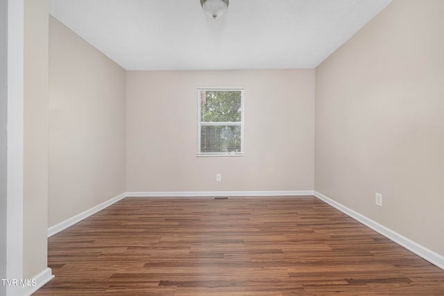 spare room with dark hardwood / wood-style floors