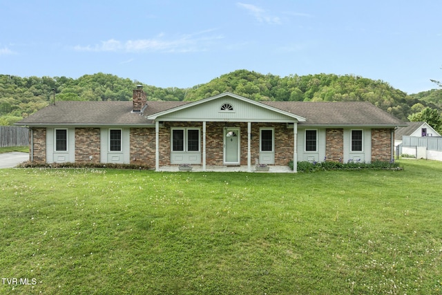 300 Wimberly Way, Bristol, TN 37620 - ranch-style house featuring a front yard, a chimney, covered porch, roof with shingles, and fence