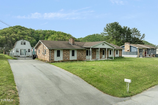300 Wimberly Way, Bristol, TN 37620 - view of front facade featuring a front lawn, driveway, covered porch, and a chimney