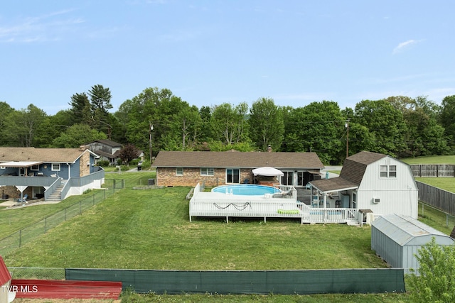 300 Wimberly Way, Bristol, TN 37620 - exterior space with a wooden deck, a fenced in pool, a storage unit, an outbuilding, and a yard